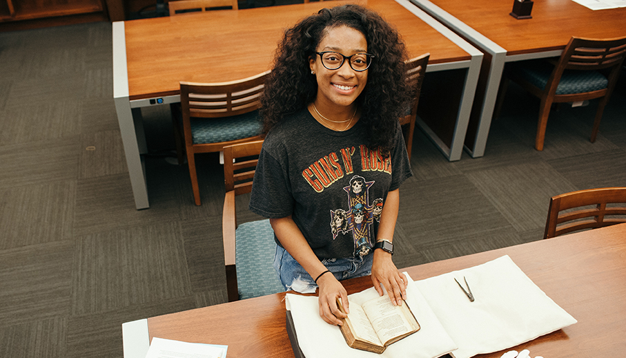 Student with a book from Archives and Special Collections.