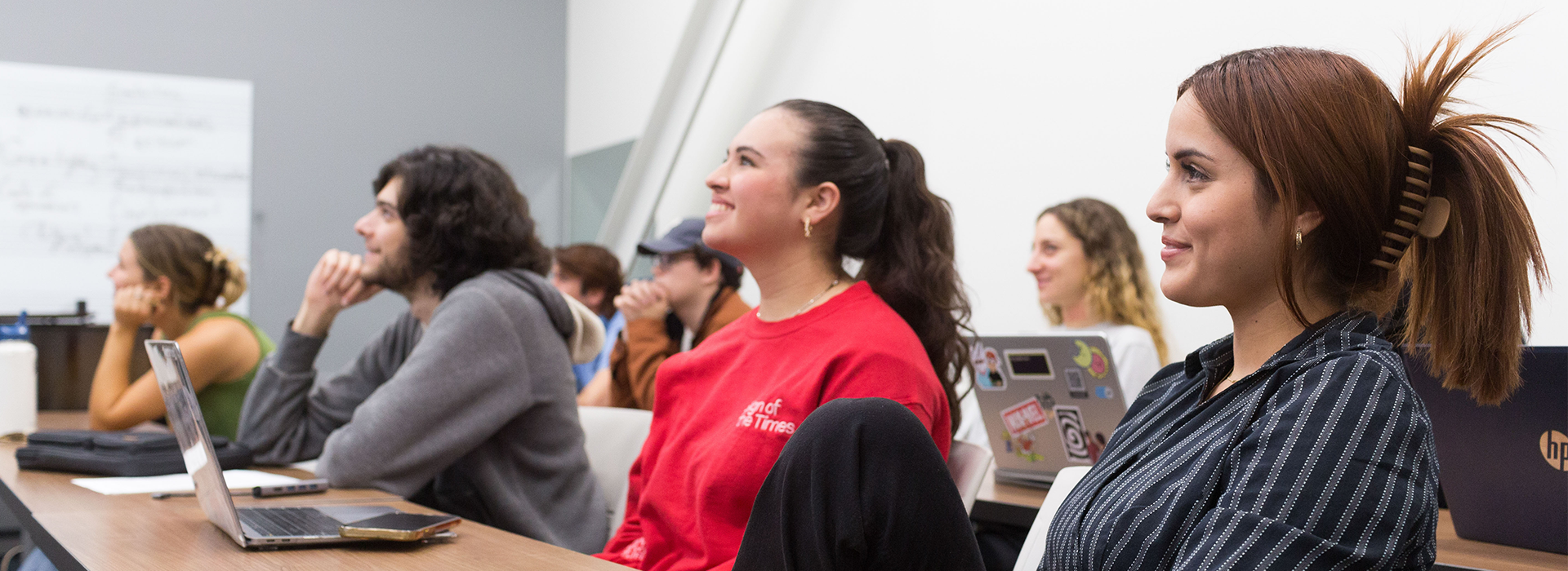 Students looking up and smiling in a classroom